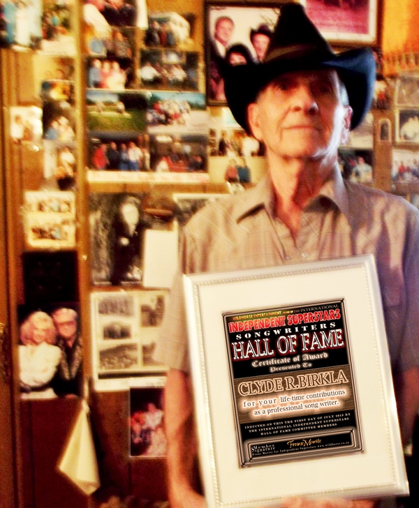 Clyde R.Birkla Holding his Hall Of Fame Award