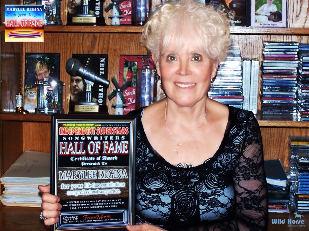"Marylee Regina" posing with her Songwriters award
